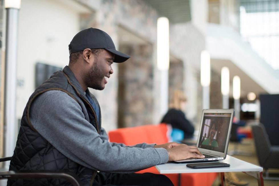 Student Looking at his Laptop